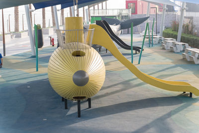 Empty chairs and table in playground