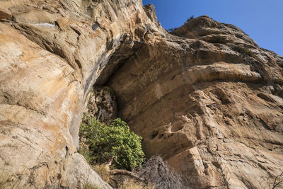 Low angle view of rock formation against sky