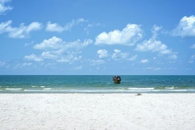 Scenic view of sea against cloudy sky