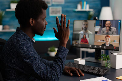 Side view of business colleagues working at office