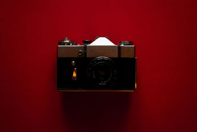 Close-up of camera against red background