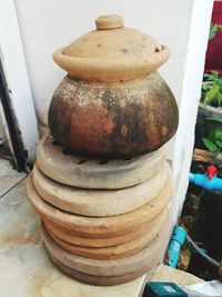 Close-up of old rusty stack on table