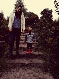 Full length of father and daughter on tree