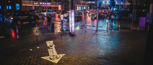 Illuminated street in city at night