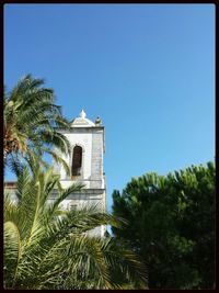 Low angle view of built structure against clear blue sky