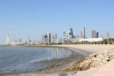 Panoramic view of beach and buildings against clear sky
