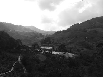 Scenic view of mountains against cloudy sky