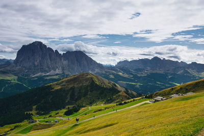 Scenic view of field and mountains against sky