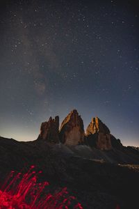 Scenic view of rock formation against sky at night