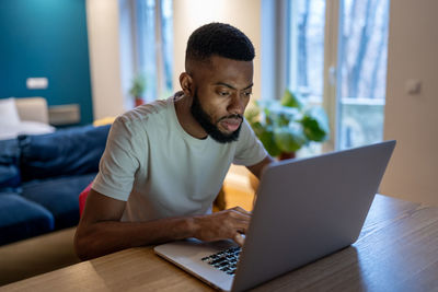 Young man using laptop at office