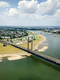 High angle view of city by sea against sky