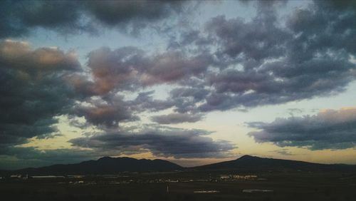 Scenic view of mountains against cloudy sky