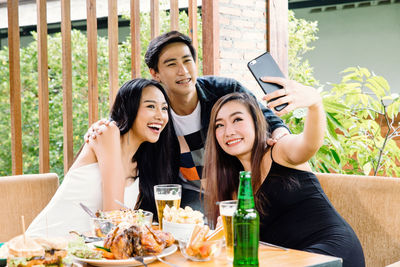 Friends taking selfie in restaurant