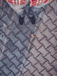 Low section of person standing on footpath