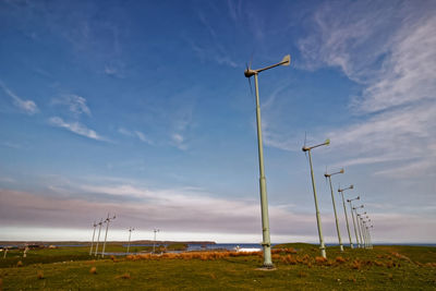 Windmill on field against sky