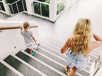 High angle view of sisters on steps