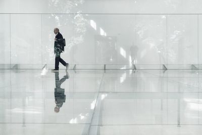 Reflection of man standing in water