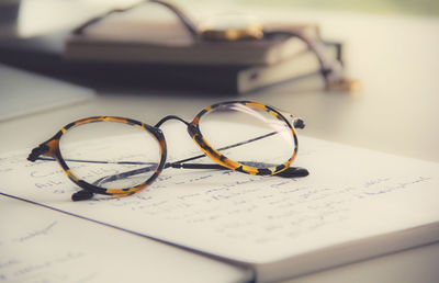 Close-up of eyeglasses on open book