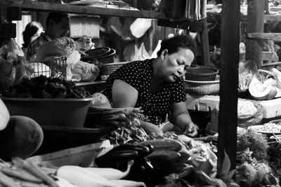 People sitting at market stall