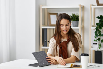 Young woman using laptop at home