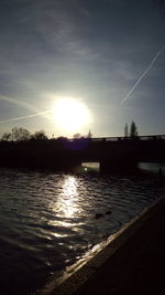 Scenic view of silhouette water against sky during sunset