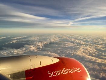 Airplane flying over clouds in sky