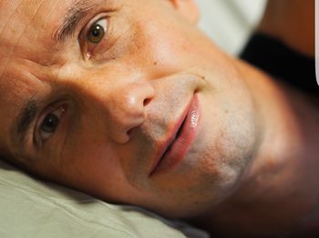 Close-up portrait of man in bed