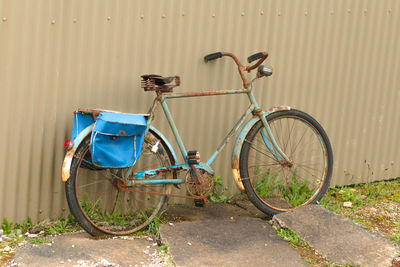 Bicycle parked against wall