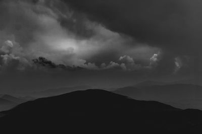 Scenic view of silhouette mountain against dramatic sky