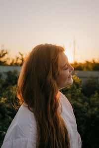 Portrait of woman against sky during sunset
