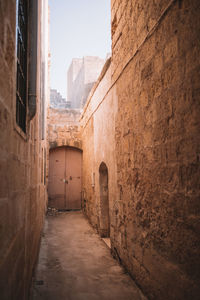 Narrow alley amidst buildings in city