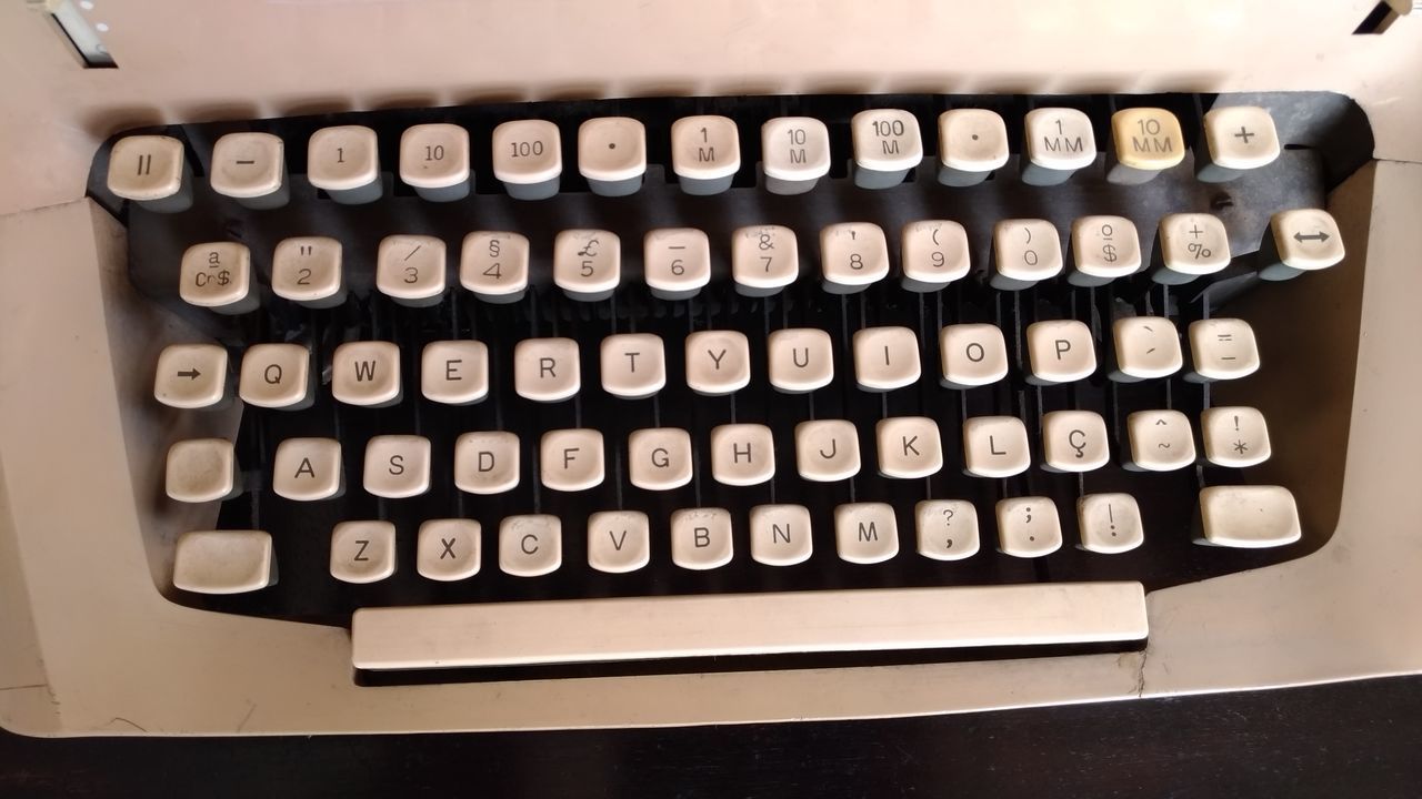 CLOSE-UP OF COMPUTER KEYBOARD ON WALL