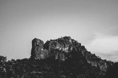 Low angle view of cliff against sky