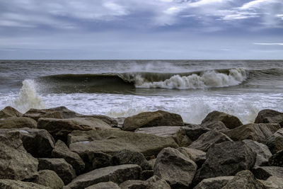 Scenic view of rocks in sea against sky