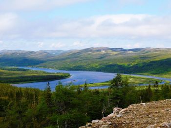 Scenic view of lake and mountains against sky