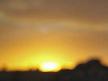 Close-up of landscape against sunset sky