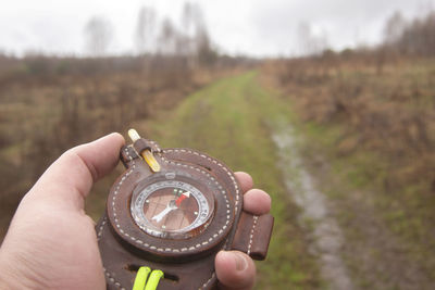 Close-up of person holding camera on field