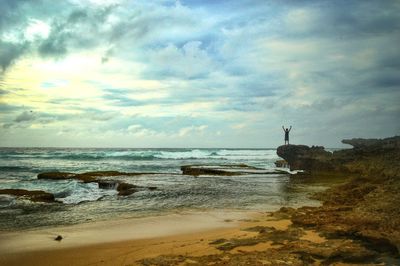 Scenic view of sea against cloudy sky