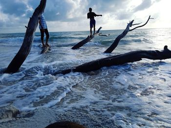 People on beach against sky