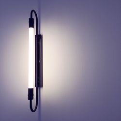 Fluorescent sconce on white wall