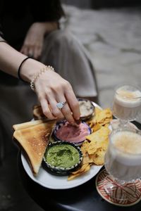 Midsection of woman having food in plate