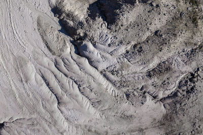 Aerial shot of abandoned opencast mine. abstract cracked mud pattern, erosion, bad land from a drone