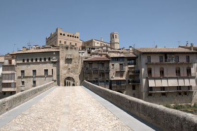 Buildings in city against clear blue sky