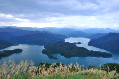 Scenic view of lake and mountains against sky