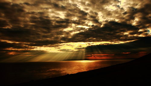 Idyllic view of seashore at sunset