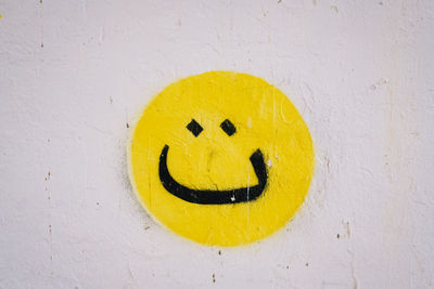 Close-up of smiley face on wall