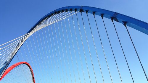 Low angle view of ferris wheel against blue sky