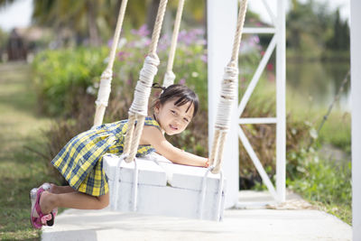 Low section of woman sitting on hammock