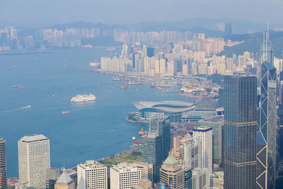 High angle view of modern city buildings by sea