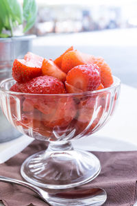 Close-up of strawberry in glass bowl at table